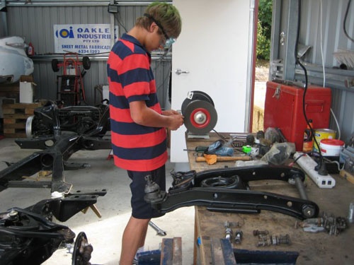 Blair cleaning up some bolts on the bench grinder.