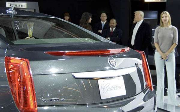 donald trump standing next to a cadillac