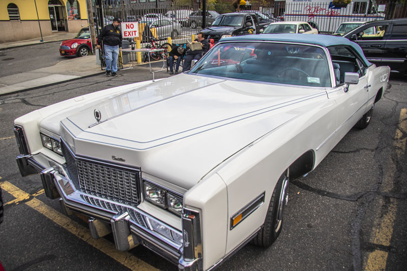 1976 white Cadillac convertible with blue roof